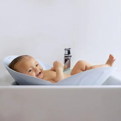 Frida Baby - Soft Sink Baby Bath Seat, Universal Over Sink Bather for Baby, Quick-drying Foldable Baby Bathtub Newborn Spa